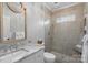 Modern bathroom with a glass-enclosed shower, marble vanity, and neutral color scheme at 18418 Turnberry Ct, Davidson, NC 28036