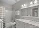 This bathroom features a tub/shower combination, double vanity, and neutral wall color at 18418 Turnberry Ct, Davidson, NC 28036