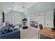 A bonus room features a treadmill, couch, desk, and window with natural light at 18418 Turnberry Ct, Davidson, NC 28036