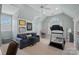 This bonus room features a treadmill, couch, desk, and window with natural light at 18418 Turnberry Ct, Davidson, NC 28036