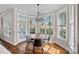 Sunlit breakfast nook features a round table, modern chairs, and large windows at 18418 Turnberry Ct, Davidson, NC 28036