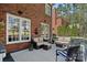 Comfortable outdoor lounge area on the deck with plush seating and a charming brick backdrop at 18418 Turnberry Ct, Davidson, NC 28036