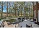 Inviting deck area with outdoor seating overlooking lush green spaces and mature trees at 18418 Turnberry Ct, Davidson, NC 28036