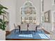 Bright dining room with hardwood floors, a stunning chandelier, and large windows overlooking the backyard at 18418 Turnberry Ct, Davidson, NC 28036