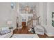 Bright, open foyer featuring hardwood floors, a staircase, and a view into the adjacent living spaces at 18418 Turnberry Ct, Davidson, NC 28036