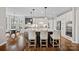 Bright kitchen and breakfast nook featuring hardwood floors, bar stool seating, and modern appliances at 18418 Turnberry Ct, Davidson, NC 28036