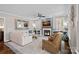 Comfortable living room with a fireplace, plush seating, a ceiling fan, and natural light at 18418 Turnberry Ct, Davidson, NC 28036