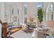Bright living room featuring high ceilings, large windows, and elegant furniture for a sophisticated feel at 18418 Turnberry Ct, Davidson, NC 28036