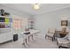 Bright home office with a large desk, ample natural light, and neutral decor at 18418 Turnberry Ct, Davidson, NC 28036