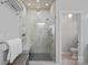 This pristine bathroom features a glass shower with a shower head, seat, and neutral walls at 18418 Turnberry Ct, Davidson, NC 28036