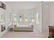 This bright and airy sitting room features a bay window, day bed, and neutral carpet at 18418 Turnberry Ct, Davidson, NC 28036