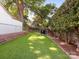 Spacious backyard featuring artificial turf, brick-lined border, and a secure fence, perfect for recreation at 2030 Radcliffe Ave, Charlotte, NC 28207