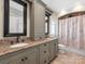 Elegant bathroom with granite countertops, dual sinks, and a decorative shower curtain at 2030 Radcliffe Ave, Charlotte, NC 28207