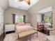 Bright bedroom with a sitting area, natural light, neutral color palette, and charming details at 2030 Radcliffe Ave, Charlotte, NC 28207