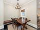 Formal dining area with seating for six and a wooden chandelier creates an inviting atmosphere at 2030 Radcliffe Ave, Charlotte, NC 28207