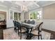 Elegant dining room featuring a coffered ceiling, large windows, and a stylish chandelier at 2030 Radcliffe Ave, Charlotte, NC 28207
