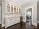 Elegant dining room features a wine fridge, custom cabinetry, and views to a sunlit breakfast nook at 2030 Radcliffe Ave, Charlotte, NC 28207