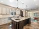 Spacious kitchen features a large center island with granite countertops, custom cabinets, and stainless steel appliances at 2030 Radcliffe Ave, Charlotte, NC 28207