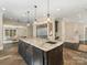 Bright kitchen features an island with sink, stainless steel appliances, and adjoins the Gathering room in an open layout at 2030 Radcliffe Ave, Charlotte, NC 28207