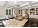 Inviting living room features a coffered ceiling, large windows, and custom built-in bookshelves at 2030 Radcliffe Ave, Charlotte, NC 28207