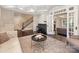 Open-concept living area with hardwood floors, piano, and view into another room at 2030 Radcliffe Ave, Charlotte, NC 28207