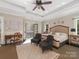 Bright main bedroom featuring tray ceilings, sitting area, and access to an outdoor terrace at 2030 Radcliffe Ave, Charlotte, NC 28207