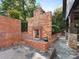 Elegant stone patio featuring a red brick fireplace with a decorative wreath and a slate tile floor at 2030 Radcliffe Ave, Charlotte, NC 28207