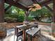 Covered patio featuring stone flooring, a dining table, and a fan for comfortable outdoor gatherings at 2030 Radcliffe Ave, Charlotte, NC 28207