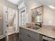 Stylish wet bar area showcasing granite countertops, custom cabinets, and a view into the half-bath at 2030 Radcliffe Ave, Charlotte, NC 28207