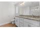 Bathroom featuring double vanity with granite countertops and a glass-enclosed shower at 2032 Summey Ave, Charlotte, NC 28205