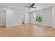 A spacious bedroom features a ceiling fan, large window, and access to a bathroom at 2032 Summey Ave, Charlotte, NC 28205