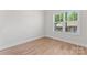 A bedroom with large windows provides lots of natural light and is complete with hardwood floors at 2032 Summey Ave, Charlotte, NC 28205