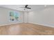 A bright bedroom with modern ceiling fan and large window providing natural light at 2032 Summey Ave, Charlotte, NC 28205