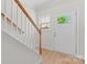 Bright entryway featuring hardwood flooring, staircase and front door with glass panel at 2032 Summey Ave, Charlotte, NC 28205