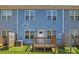 Back exterior of a blue townhouse with small decks at 2032 Summey Ave, Charlotte, NC 28205
