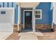 Inviting front door with transom window is flanked by the house number, sidelight, and garage door at 2032 Summey Ave, Charlotte, NC 28205