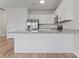 A modern kitchen features stainless steel appliances, granite countertops, and white cabinets at 2032 Summey Ave, Charlotte, NC 28205