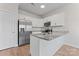 A modern kitchen features stainless steel appliances, granite countertops, and white cabinets at 2032 Summey Ave, Charlotte, NC 28205