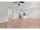 Spacious living space with an open layout, hardwood floors, and white kitchen cabinets at 2032 Summey Ave, Charlotte, NC 28205