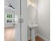 Charming powder room featuring a pedestal sink and decorative lighting fixture at 2032 Summey Ave, Charlotte, NC 28205