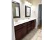 Bathroom with double vanity, framed mirrors, and neutral tile flooring, offering elegance and functionality at 216 Harrison Ln # 4, Locust, NC 28097