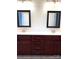 Bathroom featuring a double vanity with granite countertops and framed mirrors for modern appeal at 216 Harrison Ln # 4, Locust, NC 28097