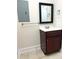 Bathroom with wood vanity cabinet, framed mirror and neutral paint color, with tile floor at 216 Harrison Ln # 4, Locust, NC 28097