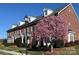 Charming brick townhome featuring a blooming tree and well-maintained landscaping at 216 Harrison Ln # 4, Locust, NC 28097