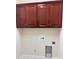 Laundry room with cherry wood cabinets, utility sink and hookups for washer and dryer at 216 Harrison Ln # 4, Locust, NC 28097