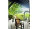 The exterior features a patio with chairs and climbing plants with green grass beyond at 216 Harrison Ln # 4, Locust, NC 28097