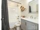 Updated bathroom with a shower-tub combo, vanity sink, and a decorative shower curtain at 2313 Glenwood St, Kannapolis, NC 28083
