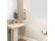 Cozy half bathroom features a square mirror, pedestal sink, and a neutral color scheme at 2313 Glenwood St, Kannapolis, NC 28083