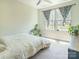 Serene bedroom with a large window, plant decor, a ceiling fan, and carpeted floors at 2313 Glenwood St, Kannapolis, NC 28083