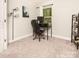 Cozy bedroom featuring a window with natural light, carpeted floors, and a desk at 2313 Glenwood St, Kannapolis, NC 28083